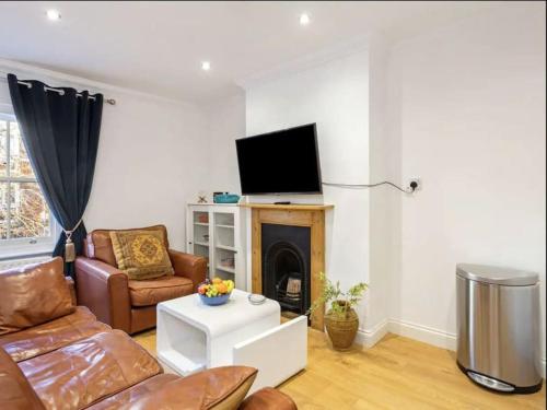 a living room with a couch and a fire place at Winchester Nest in Winchester