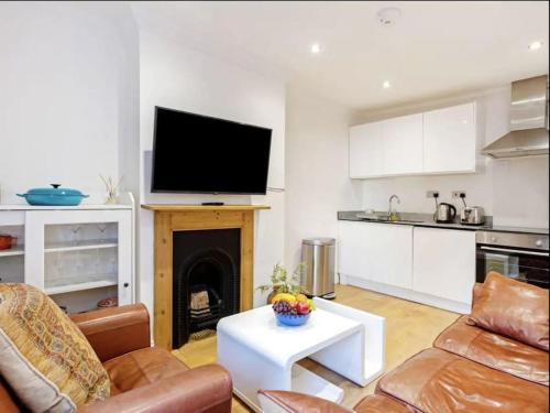 a living room with a television and a fireplace at Winchester Nest in Winchester