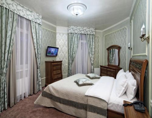 a bedroom with a bed and a mirror and curtains at Svityaz Resort in Truskavets