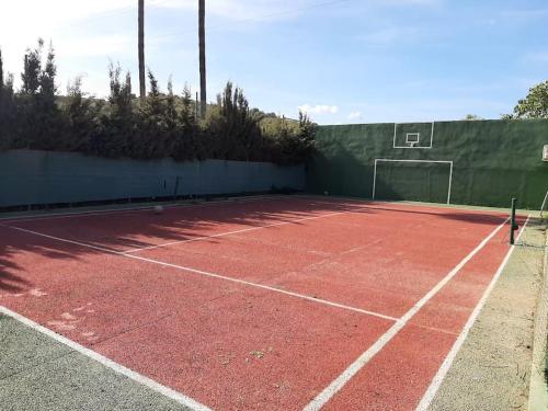 a tennis court with a net on top of it at R Gem by the Sea in Vélez-Málaga