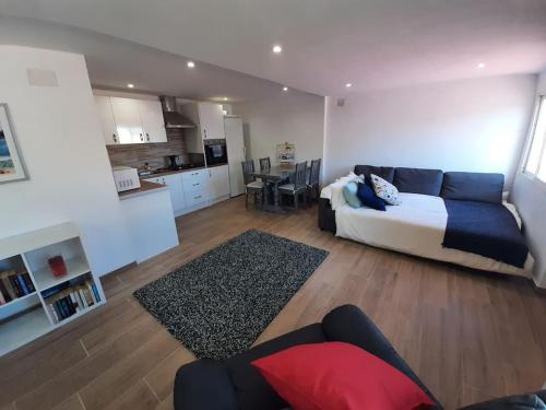 a living room with a couch and a kitchen at R Gem by the Sea in Vélez-Málaga