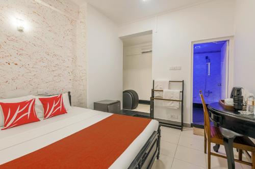 a bedroom with a bed and a blue door at Beverly Hills Hotel in Mount Lavinia