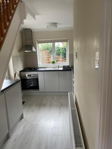 a kitchen with a sink and a stove at Charming just renovated 2 bed cottage in the centre of village in Hartford