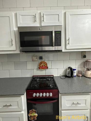 a kitchen with a stove top oven with a microwave at Ifson Home_1 in Kankamsen