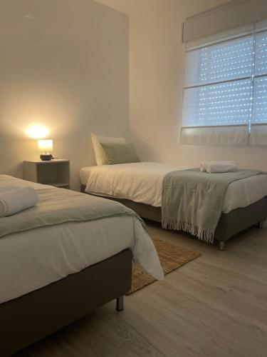 Giường trong phòng chung tại Cantinho da Rosa - Terras de Bouro