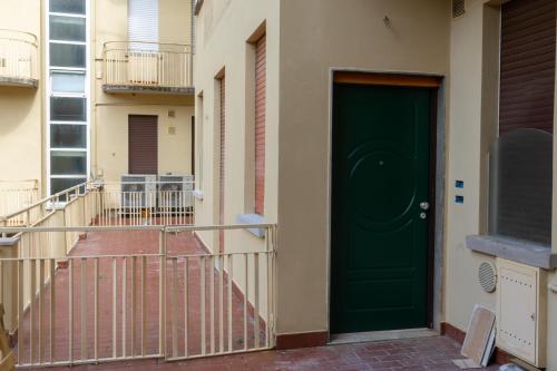 a green door on the side of a building at PALAZZO NOVECENTO Centro Storico in Lecco