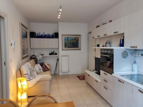 a living room with a couch and a kitchen at A casa di Milena in Porto Recanati