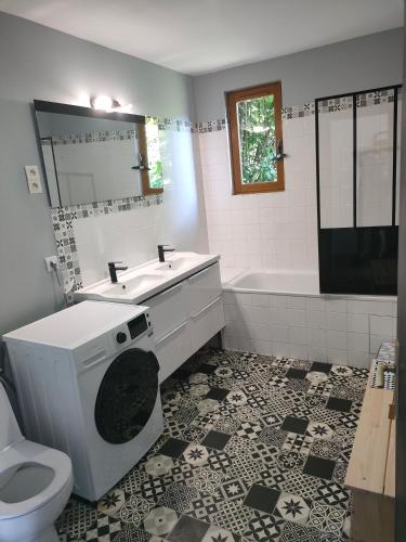 a bathroom with a sink and a toilet and a tub at Lona in Aydat