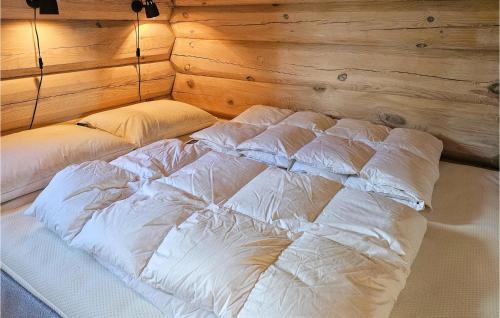 a bed with white sheets and pillows in a room at Beautiful Home In Sr-fron With House A Mountain View in Kvitfjell