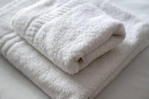 a pile of white towels sitting on a table at GuestReady - Fantastic Location in Islington in London