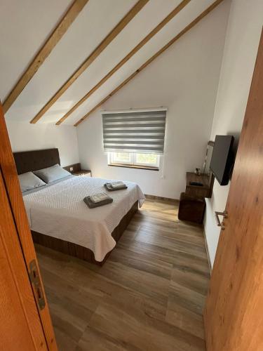 a bedroom with a large bed and a window at Zanes Guest House in Kladovo