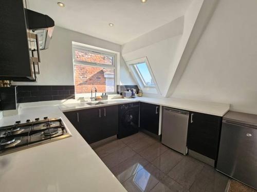 a kitchen with a sink and a counter top at 2 bedroom Flat in Camden in London