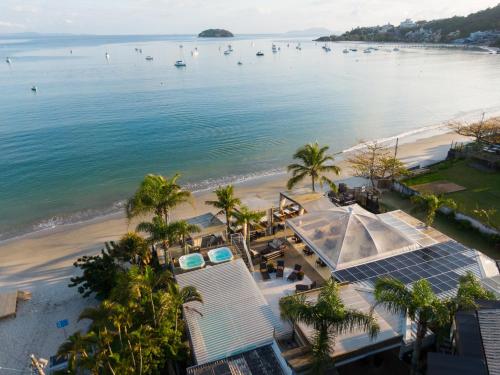 an aerial view of a beach with palm trees at Pousada dos Sonhos in Florianópolis
