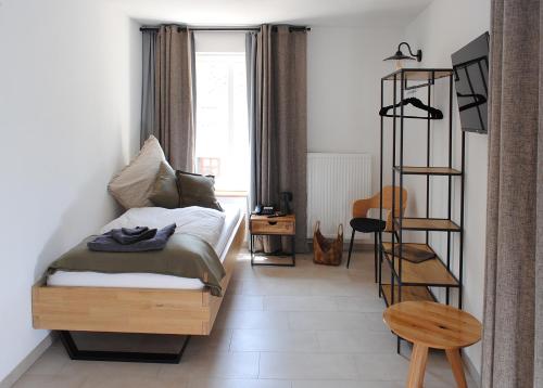 a bedroom with a bed and a ladder in a room at Landhaus Gräfendhron in Gräfendhron