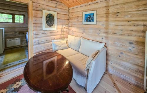 a room with a table and a couch in a cabin at Beautiful Home In Sr-fron With House A Mountain View in Kvitfjell