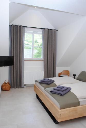 a bedroom with a bed and a window at Landhaus Gräfendhron in Gräfendhron