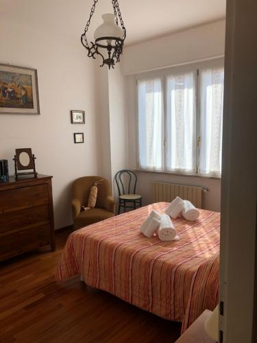 a bedroom with a bed with two towels on it at Annarosa in Sarzana