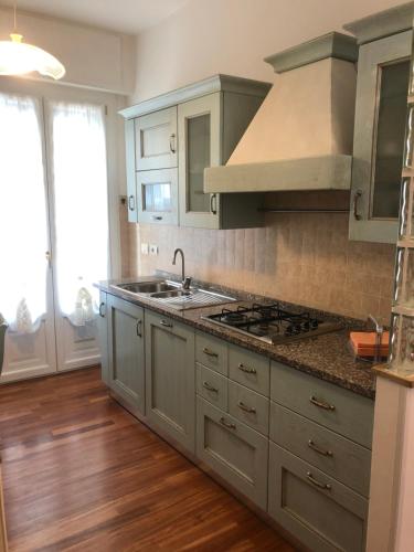 a kitchen with a sink and a stove at Annarosa in Sarzana