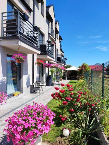 a garden with pink flowers in front of a building at 4 Foxes in Ustka