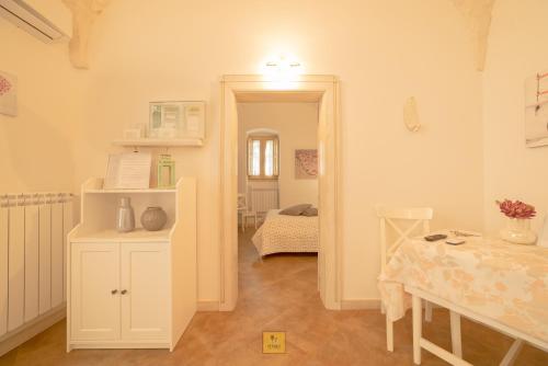 a room with a table and a room with a dining room at Petralù - Casa Vacanza zona centro in Locorotondo