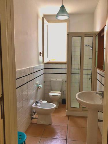 a bathroom with two toilets and a sink at Borgo Marino Plemmirio in Siracusa