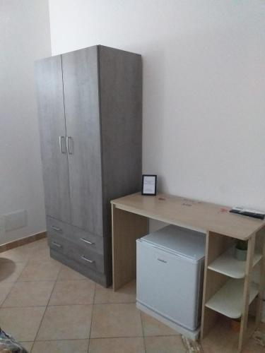 an office with a wooden desk and a cabinet at Affittacamere da Arianna in Porto Torres