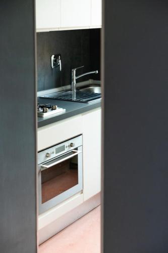 a kitchen with a sink and a stove at Navona 49 Luxury Suites&Apartment in Rome