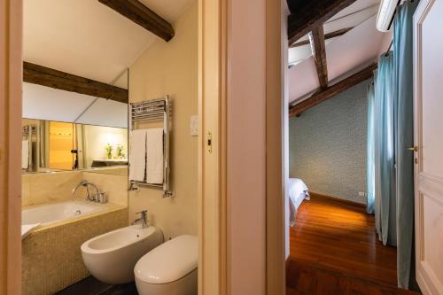 a bathroom with a sink and a toilet and a tub at Navona 49 Luxury Suites&Apartment in Rome