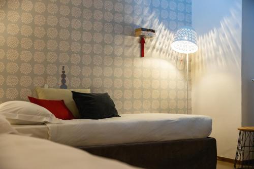 a living room with a white couch and a lamp at Navona 49 Luxury Suites&Apartment in Rome