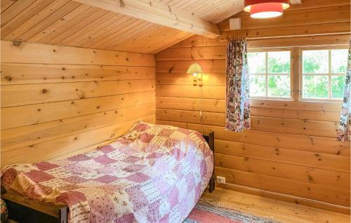 a bedroom of a log cabin with a bed in it at Nice Home In Selje With Wifi in Stokke