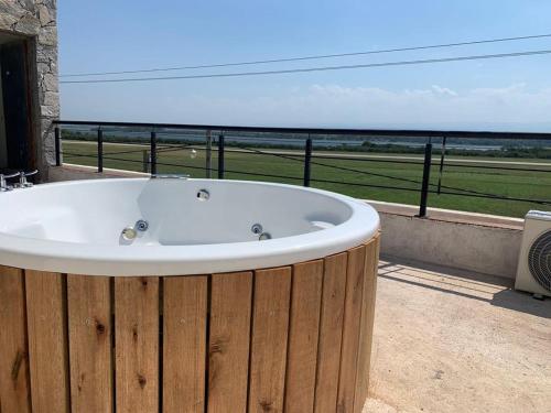 a bath tub sitting on a balcony with a view of the ocean at DINASTIE COUNTRY APART in Villa Rumipal