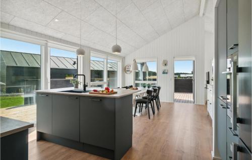 a kitchen and dining room with a table and chairs at Cozy Home In Grenaa With Kitchen in Brøndstrup
