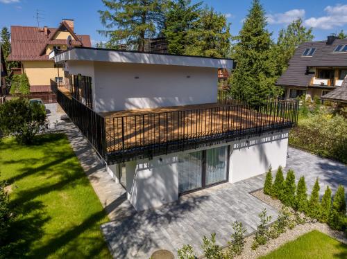 an aerial view of a house with a balcony at Tatry Mozaika Willa PREMIUM & SPA - Sauna, Jacuzzi, Flipper by RentiloPL in Zakopane