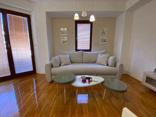 a living room with a couch and a table at SI Apartments Ohrid with free parking in Ohrid