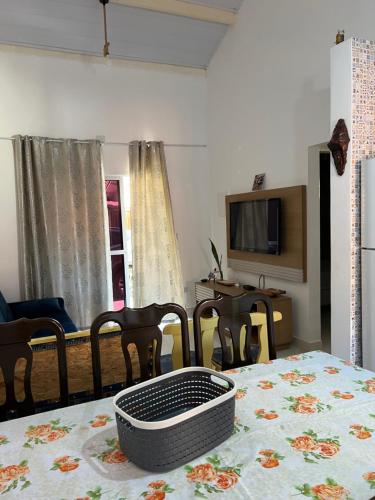 a living room with a table with a table cloth on it at Chalé em Resort in Mairinque