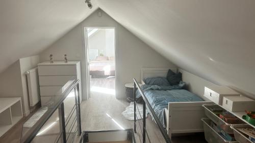 a attic room with a bed and a bedroom at Au petit alveo in Sprimont