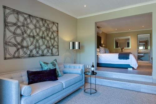 a living room with a couch and a bed at The Jordan Suites in Stellenbosch