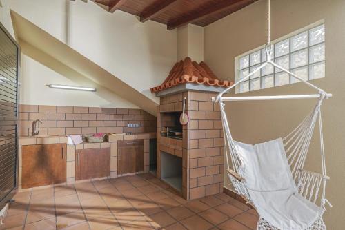 a kitchen with a hammock hanging from the ceiling at Casa das Raposinhas II in Funchal