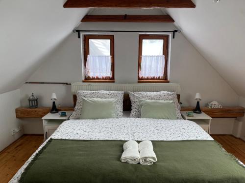 a bedroom with a large bed with two pairs of shoes at Apartmán Z.E.M. 