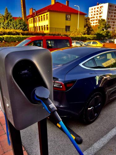 a car is parked next to a parking meter at Boutique Hotel & Event Center in Budapest