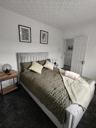 a bedroom with a large bed and a table at 3 bedroom house in Grays Thurrock
