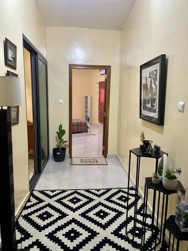 a living room with a large mirror and a tile floor at Reema B&B in Dakar