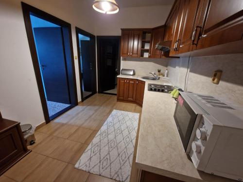 a kitchen with wooden cabinets and a stove top oven at Villa Florencia in Bardejov