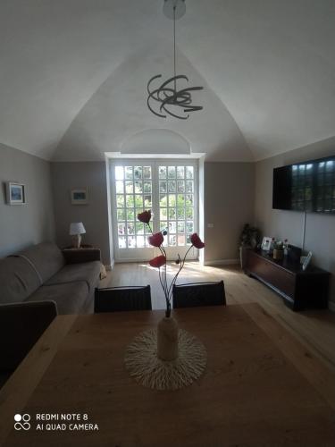 a living room with a table and a couch at Pergolato suite in Sanremo