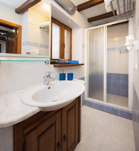 a bathroom with a sink and a shower at Harbour Holiday Home "Vilmin Dvor" in Murter