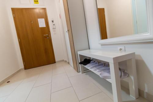 a bathroom with a sink and a mirror and a door at Gajeva Rooms - Malmö apartment SELF CHECK-IN in Virovitica