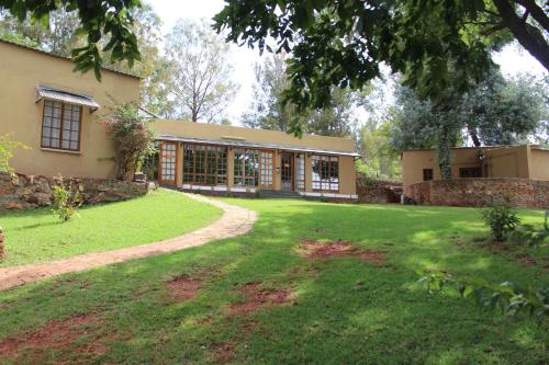 a building with a yard in front of it at The Cradle Berry Farm in Muldersdrift