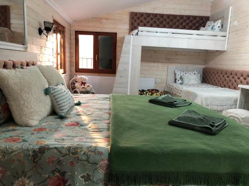 a bedroom with a large bed and a bunk bed at Vila Relax Valiug Crivaia in Văliug