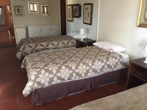 a hotel room with two beds in a room at The Cradle Berry Farm in Muldersdrift