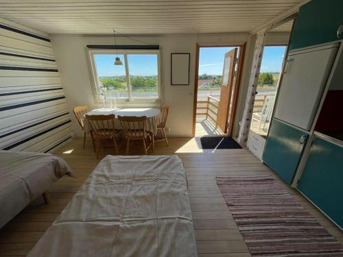 a room with a table and chairs and a dining room at Cozy cottage stay in Falkenberg